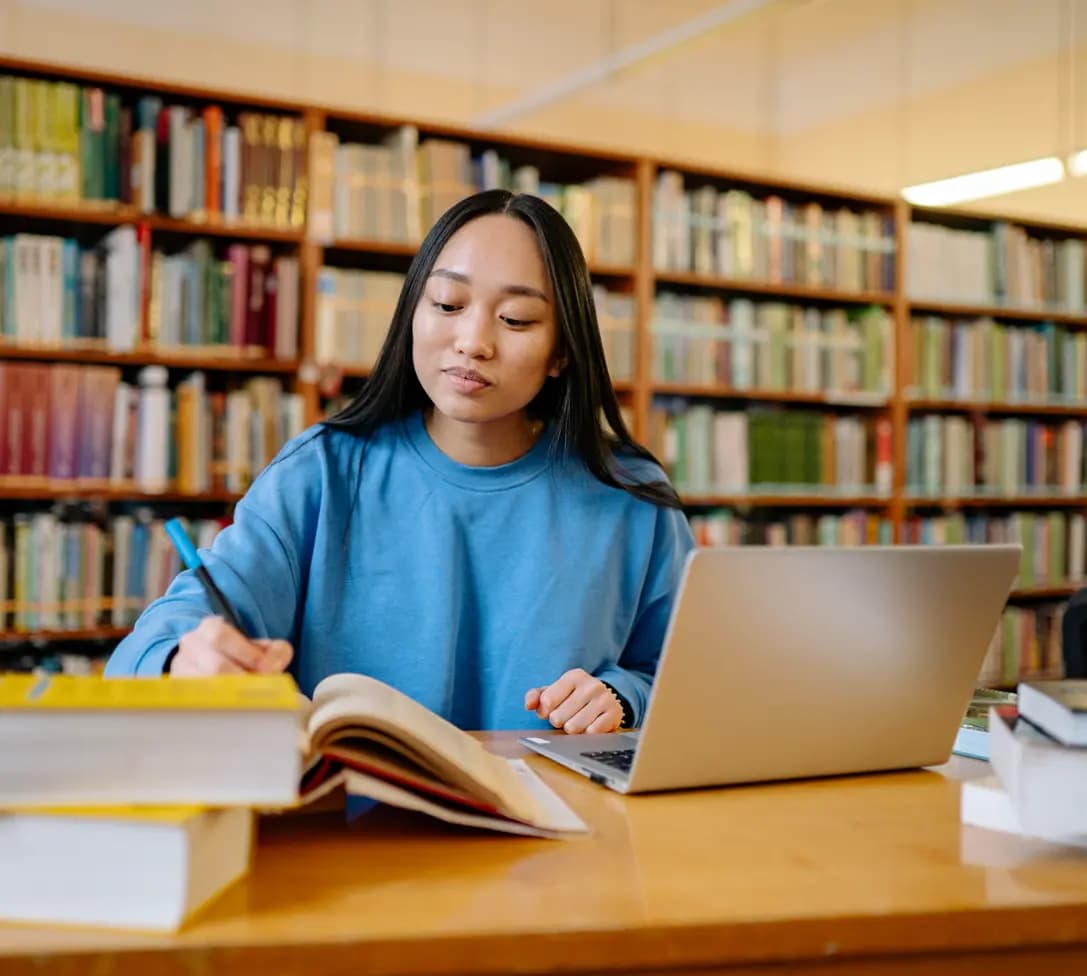 A student working through practice on a laptop in a library